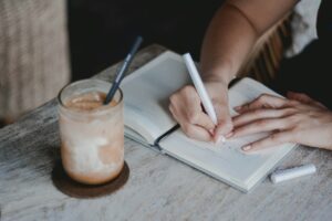 Person writing on white paper
